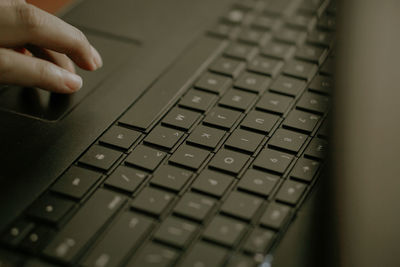 Close-up of hand using laptop