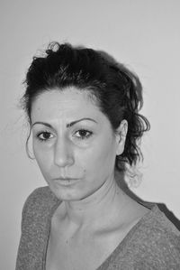 Close-up portrait of young woman against white background