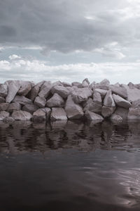 Rocks in sea against sky