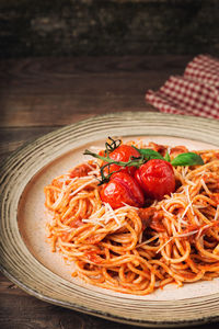 Noodles with strawberry and salad in plate on table