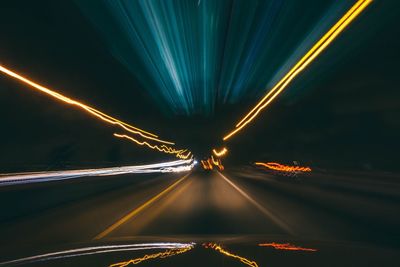 Blurred motion of car on road at night