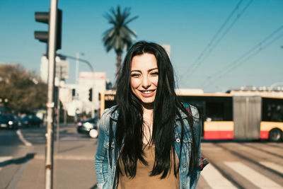 Portrait of smiling young woman standing outdoors