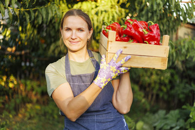 Portrait of young woman holding gift