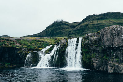 Scenic view of waterfall against clear sky