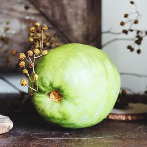 Close-up of green fruit on table