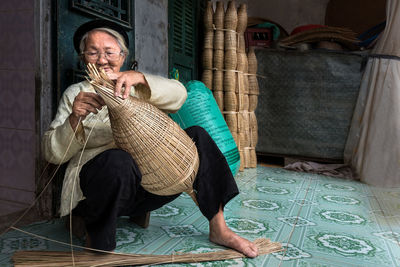 Midsection of man holding woman sitting at home