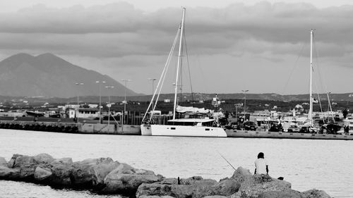 Sailboats in sea against sky