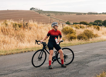 Man riding bicycle on field