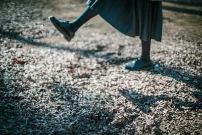 Low section of woman walking on street