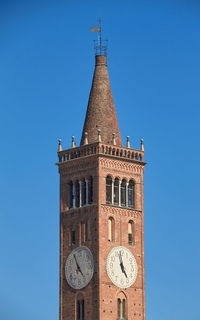 Low angle view of clock tower against clear blue sky