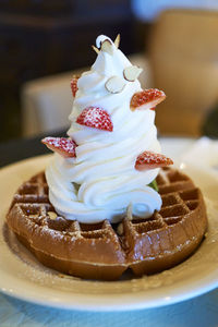 High angle view of waffle and cream served in plate
