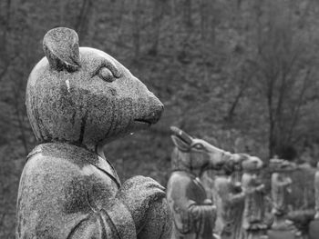 Close-up of statues against mountain