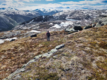 Rear view of man standing on mountain