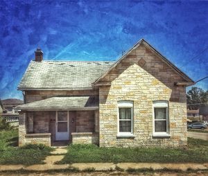 Facade of abandoned house against sky