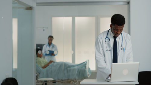 Doctor working on laptop at hospital