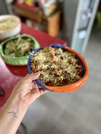 Cropped hand of woman holding food