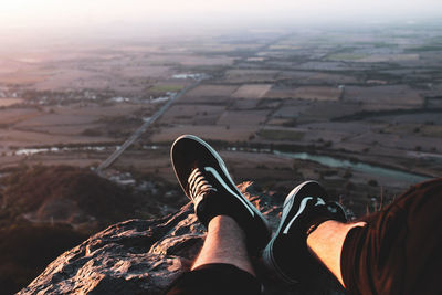 Low section of person relaxing on land