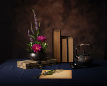 Close-up of purple flower vase on table