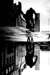 Full length of silhouette man against building in city