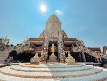 Temple by building against sky