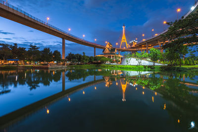 View of bridge over river at night