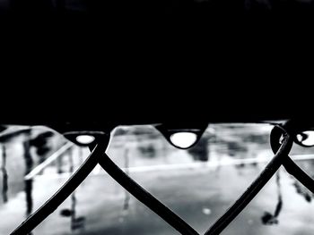 Close-up of illuminated metal against sky at night