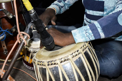 High angle view of man playing tabla at ceremony