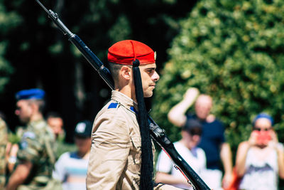 Rear view of man holding umbrella