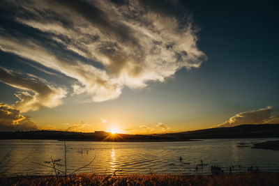 Scenic view of lake against sky during sunset