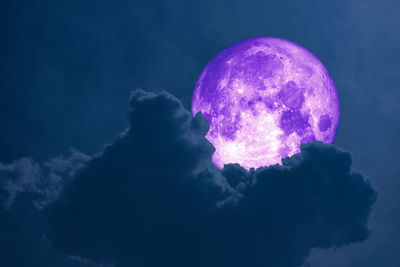 Low angle view of moon against blue sky