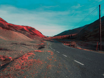 Road amidst mountains against sky