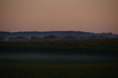 Scenic view of field against sky during sunset