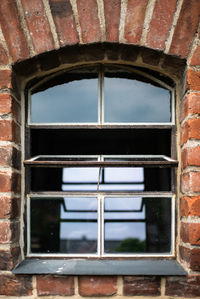 Low angle view of window in abandoned building