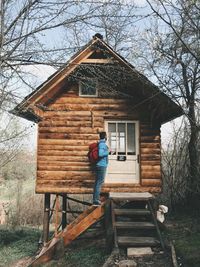 Man standing in front of treehouse