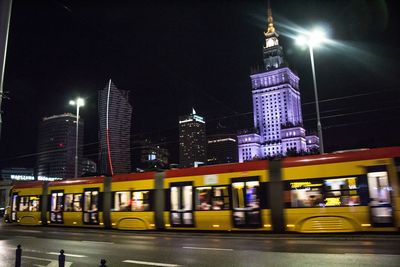 Illuminated city street at night