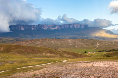 Scenic view of landscape and mountains against sky