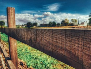 Fence on field against sky