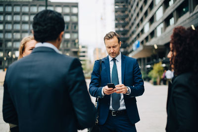 Friends standing on a mobile phone