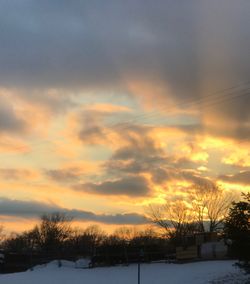 Scenic view of snow field against sky at sunset