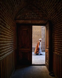 Woman standing at entrance of building