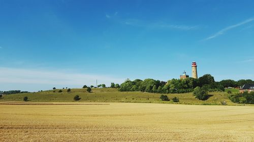 Countryside landscape against blue sky