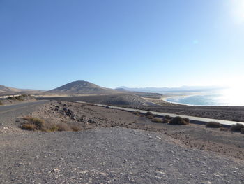 Surface level of road against clear sky