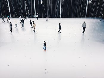 High angel view of people walking on floor