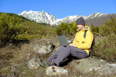 Man working with a laptop computer in nature. health at work