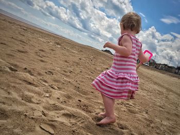 Full length of girl playing on beach