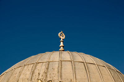 Low angle view of sculpture against blue sky