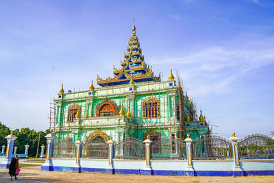 View of temple building against cloudy sky