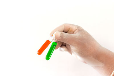 Close-up of hand holding over white background