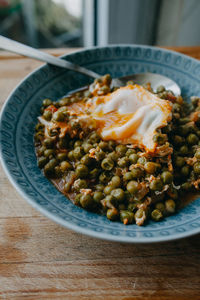 Close-up of peas ang egg served in plate