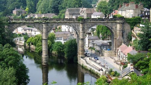 High angle view of viaduct over river amidst buildings